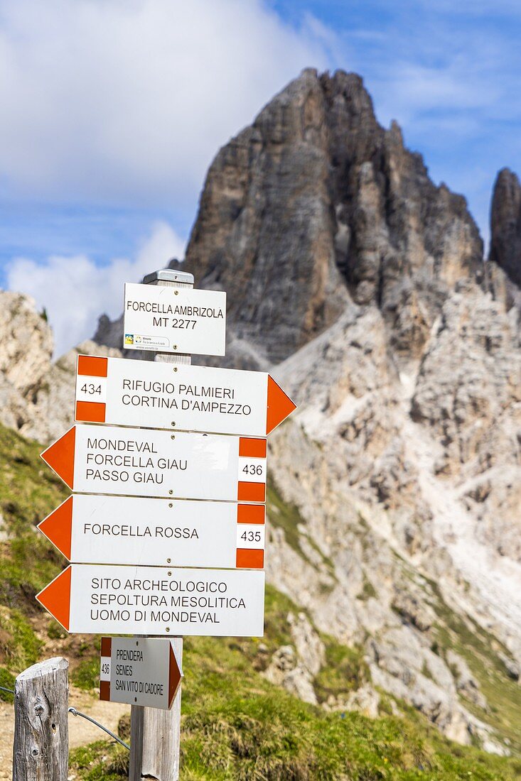 Signage of hiking trails with Forcella Ambrizzola on background, Ampezzo Dolomites, Belluno province, Veneto, Italy