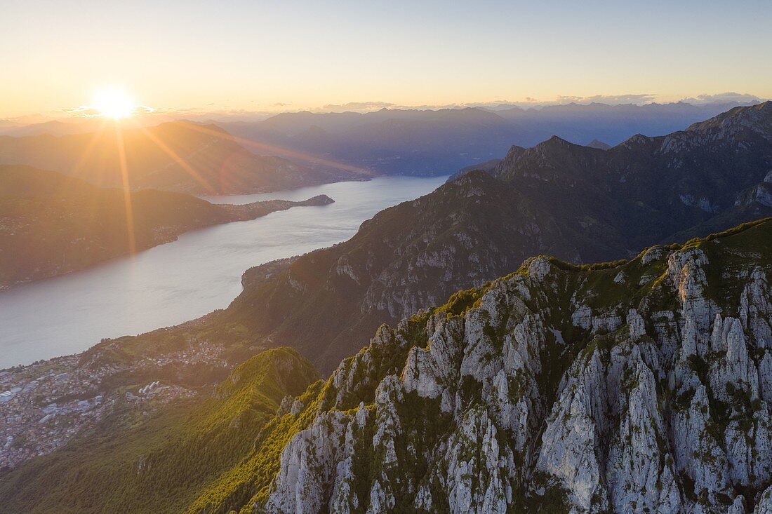 Sunset over Abbadia Lariana and Mandello Del Lario towns on shores of Lake Como, aerial view, Lecco province, Lombardy, Italy