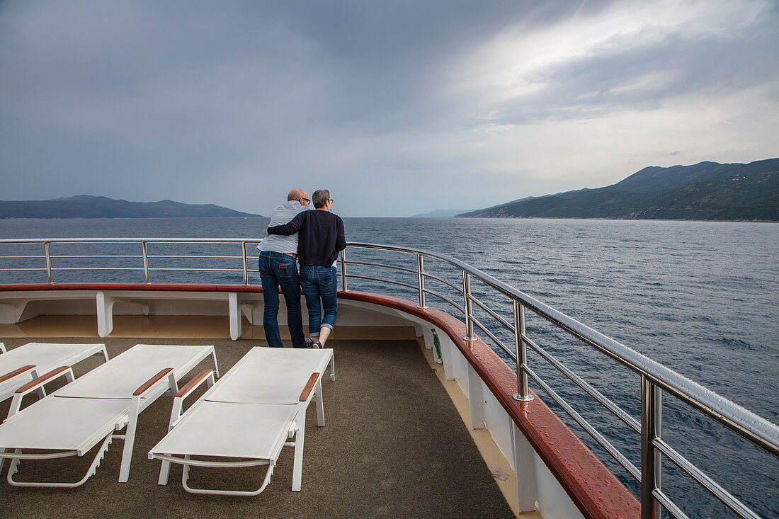 Couple on deck of cruise ship, near Opatija, Primorje-Gorski Kotar, Croatia, Europe