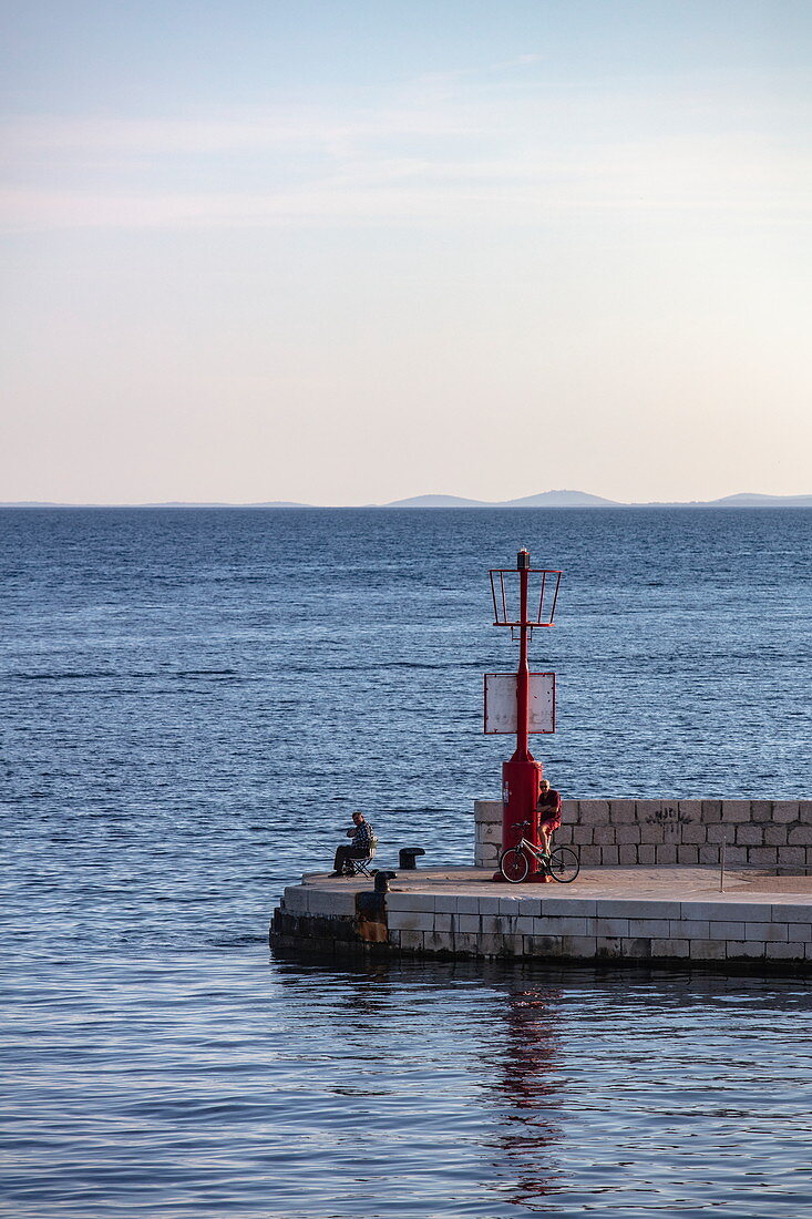 Fishermen at the end of the jetty, Rab, Primorje-Gorski Kotar, Croatia, Europe