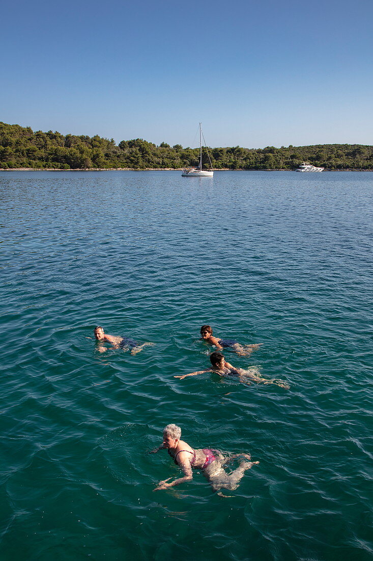 Passengers of the cruise ship swim in a pristine bay, near Kukljica, Zadar, Croatia, Europe