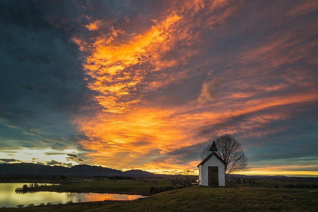 The chapel on the Riegsee in front of a dramatic evening sky, Aidling, Murnau, Bavaria, Germany