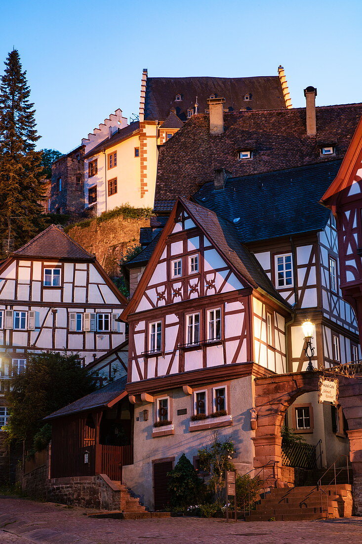 Half-timbered houses at the historic Schnatterloch market square with Mildenburg Castle at dusk, Miltenberg, Spessart-Mainland, Franconia, Bavaria, Germany, Europe