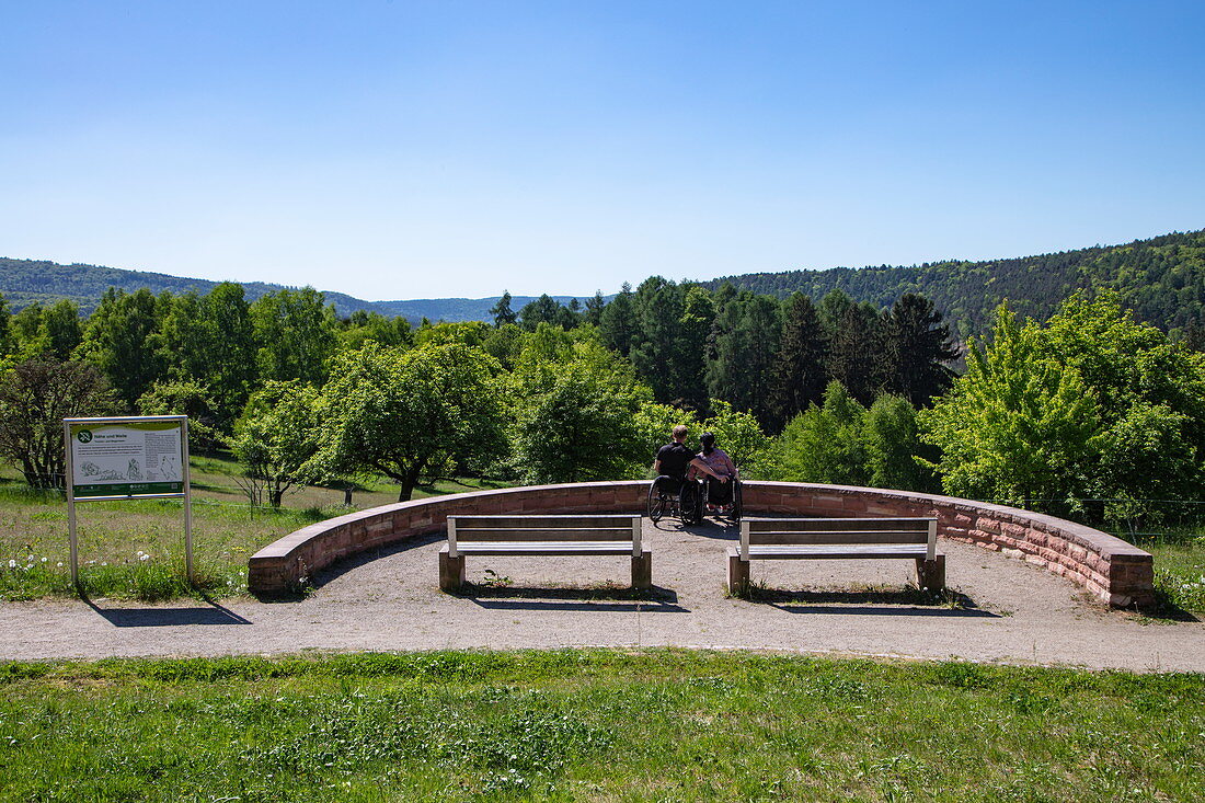 Couple in wheelchairs enjoys the view from a viewpoint on a path suitable for the disabled, near Mespelbrunn, Räuberland, Spessart-Mainland, Franconia, Bavaria, Germany, Europe
