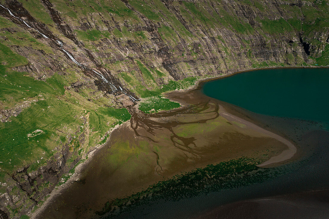 Bay with waterfall and watercourse at Saksun on the island of Streymoy in the Faroe Islands