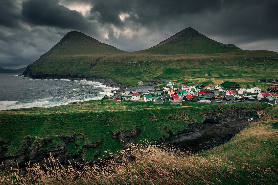 Village of Gjogv on Eysteroy with gorge, sea and mountains, Faroe Islands