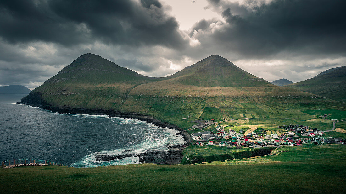 Village of Gjogv on Eysteroy with gorge, sea and mountains, Faroe Islands