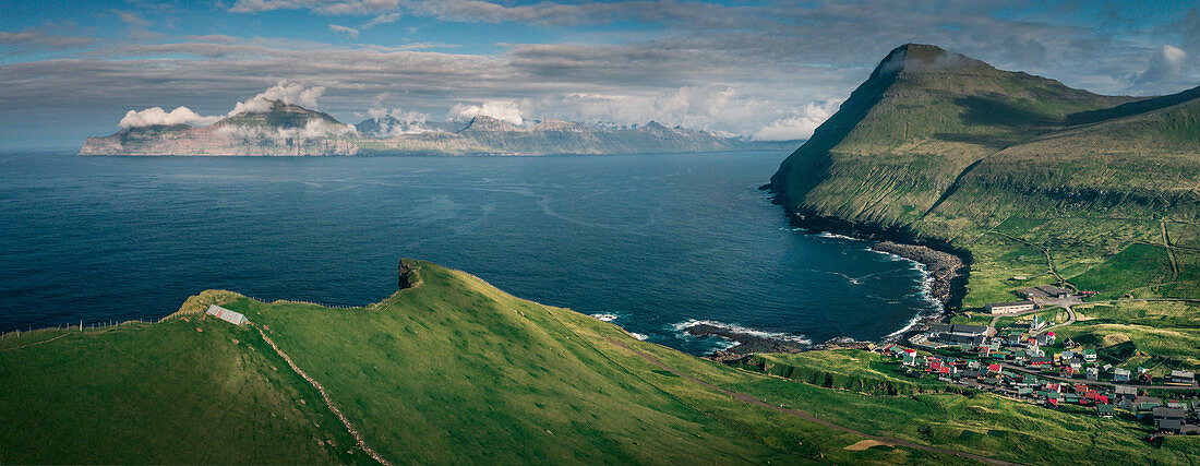 Village of Gjogv on Eysteroy with gorge, sea and mountains, Faroe Islands