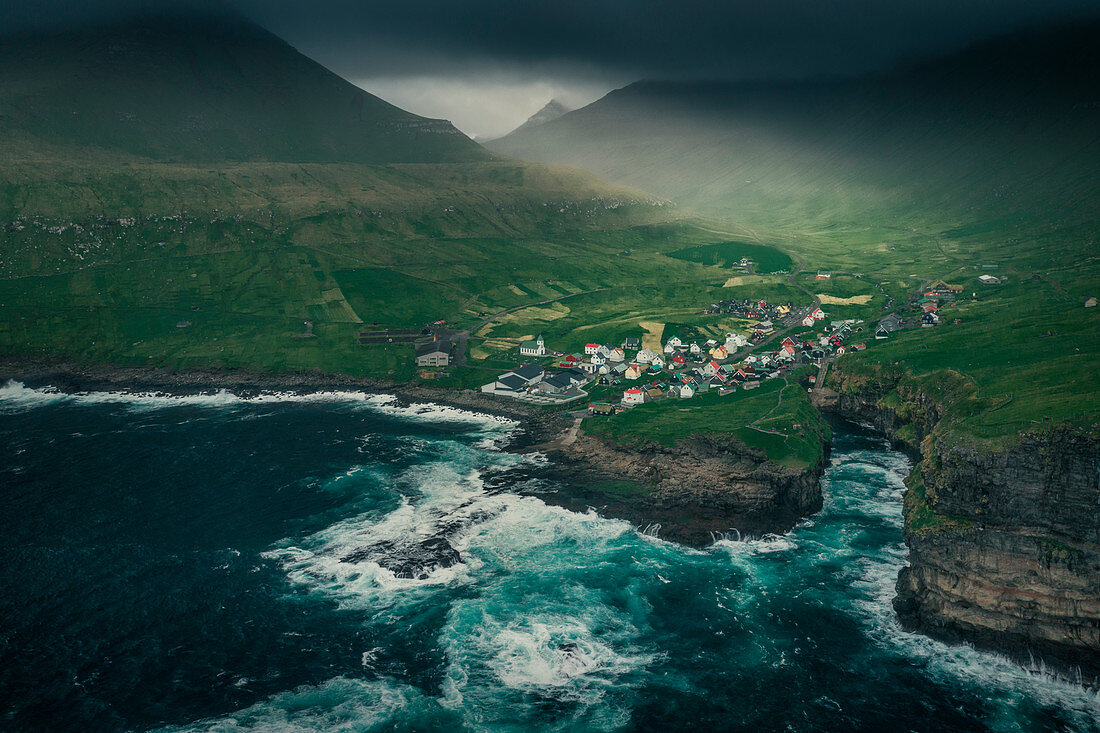 Village Gjogv on Eysteroy with gorge, sea and mountains, from above, Faroe Islands