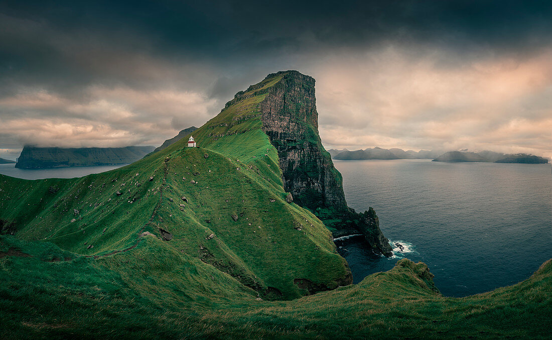 Kalsoy lighthouse with steep cliffs, Faroe Islands