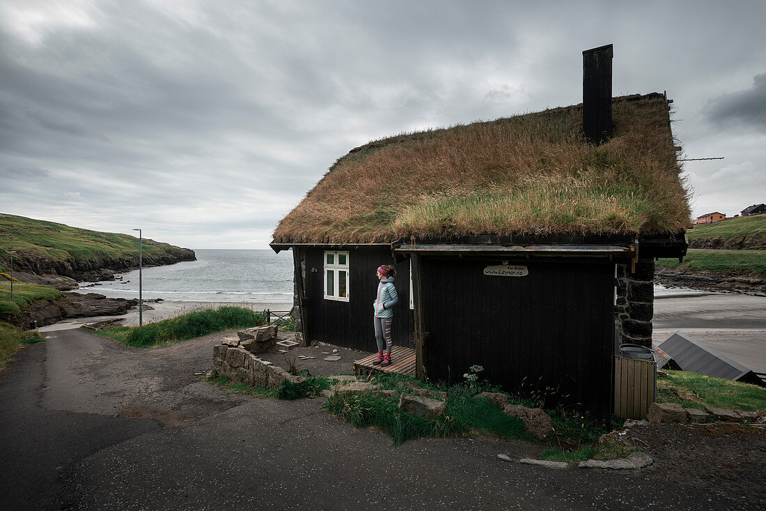 House with a grass roof in Leynar Bay, Faroe Islands