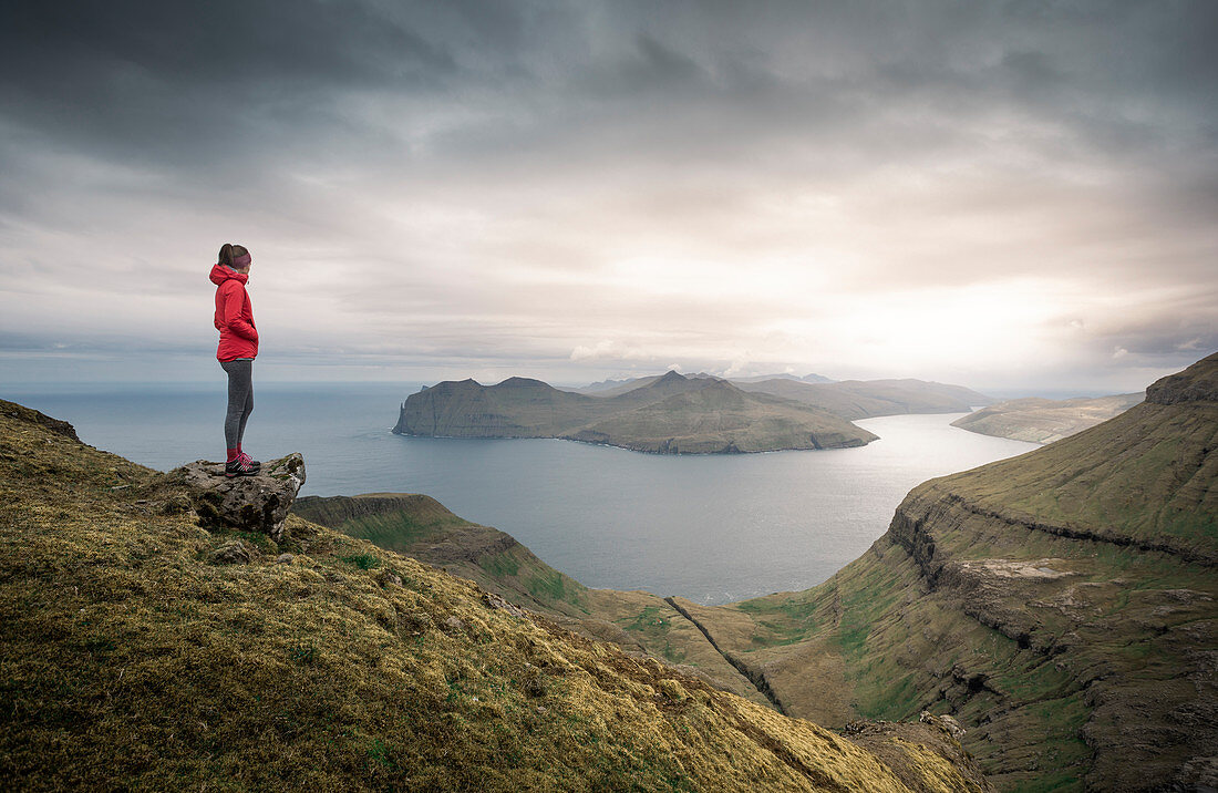 Woman in panorama of Streymoy and Vagar with clouds, Faroe Islands