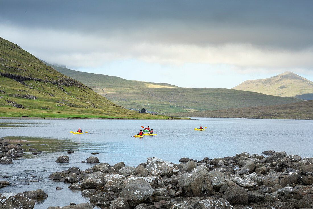Group kayakers on the Leitisvatn lake in Vagar, Faroe Islands