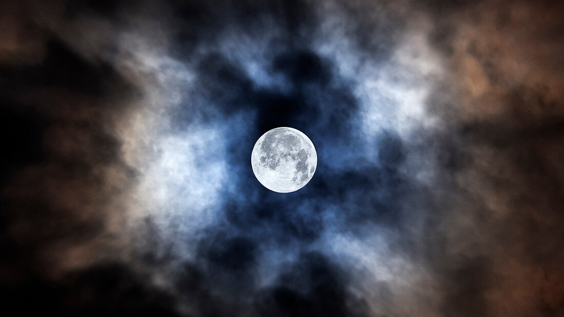 The moon between clouds