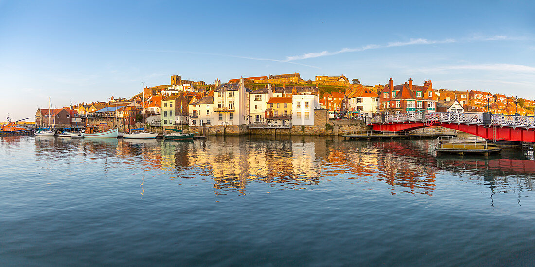 View of St. Mary's Church and reflections on River Esk at sunset, Whitby, Yorkshire, England, United Kingdom, Europe