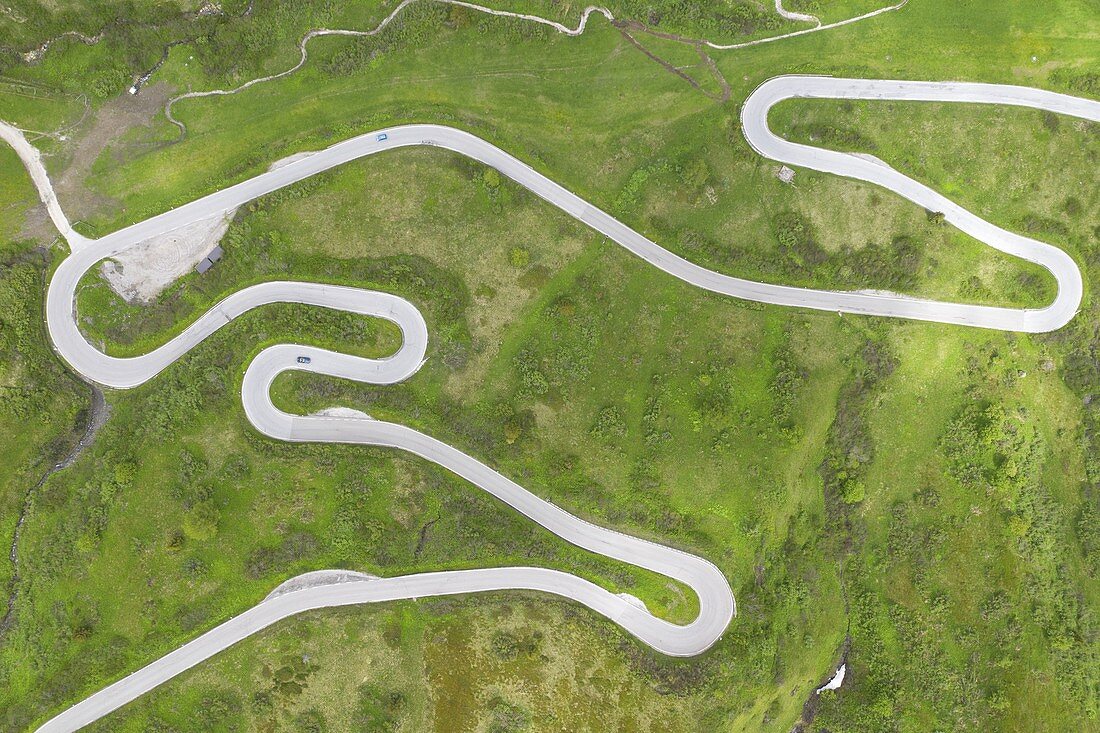 vertical aerial view taken from the drone of the winding road of the Pordoi Pass during a summer day, Fassa Valley, Dolomiti, municipality of Canazei, Trento province, Trentino Alto Adige district, Italy, Europe