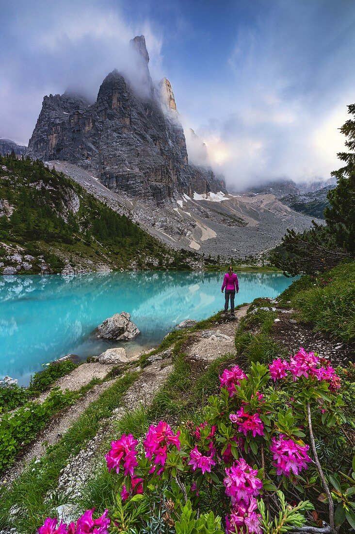 A girl observes sunset at Sorapiss lake in front of God finger, Cortina di Ampezzo, Belluno, Veneto, Italy, Southern Europe