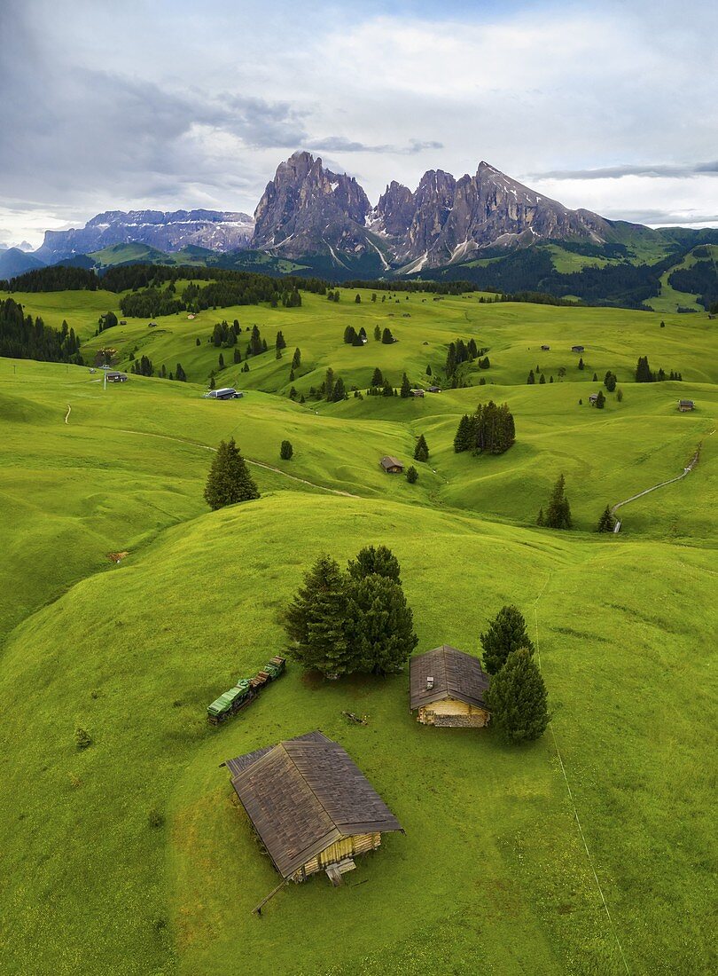 Aerial view of the Alpe di Siusi/Seiser Alm, a dolomite plateau and the largest high-altitude alpine meadow in Europe, at sunset. Castelrotto, South Tyrol, Trentino Alto Adige, Italy, Europe.