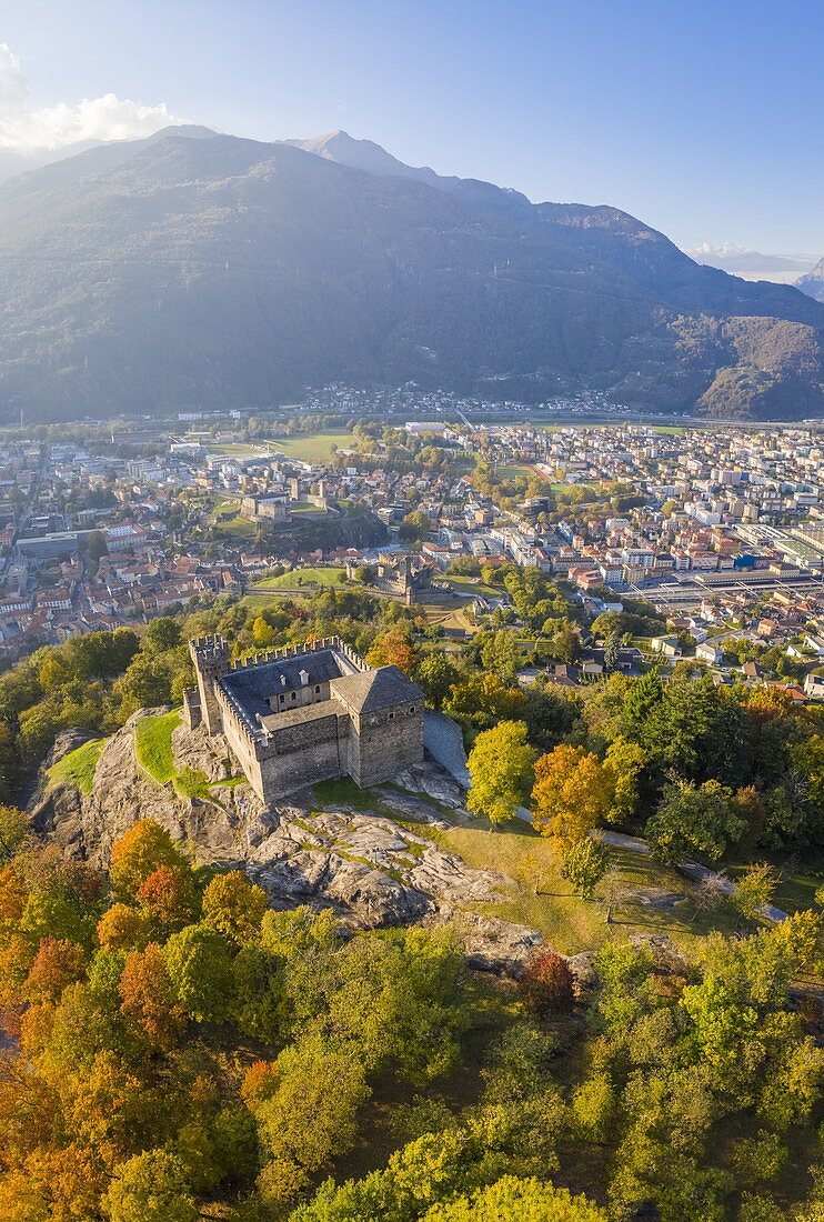 Aerial view of the medieval Bellinzona castles, Unesco World Heritage site, in autumn at sunset. Canton Ticino, Switzerland.