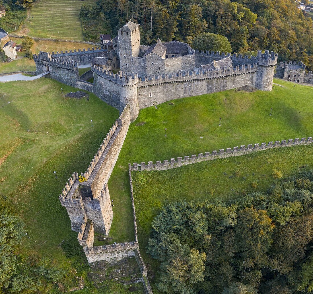 Aerial view of the medieval Bellinzona castles, Unesco World Heritage site, in autumn at sunset. Canton Ticino, Switzerland.