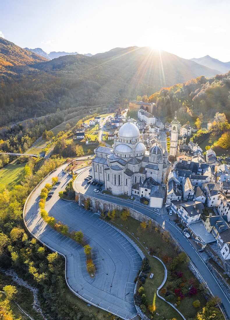Aerial view of the Santuario della Madonna del Sangue sanctuary in the town of Re during an autumnal sunset. Re, Valle Vigezzo, val d'Ossola, Verbano Cusio Ossola, Piedmont, Italy.