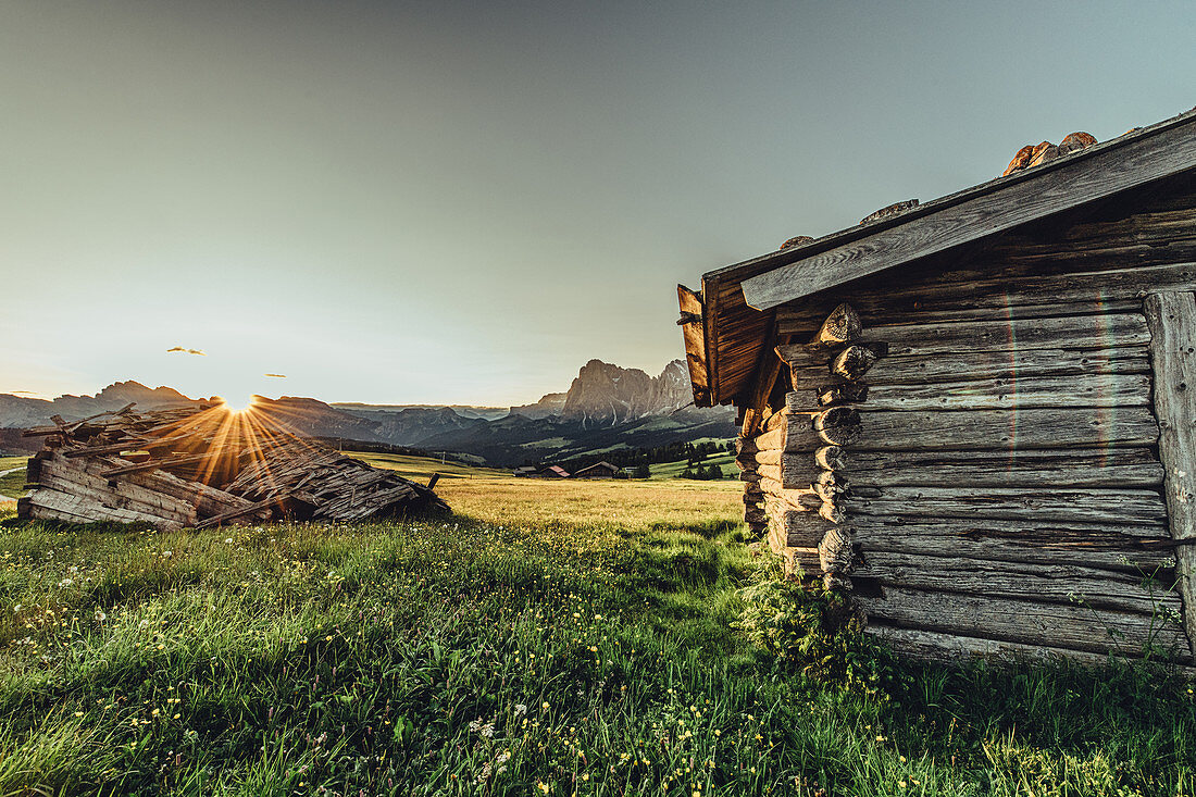 destroyed hut at sunrise on the Seiser Alm in South Tyrol, Italy, Europe;