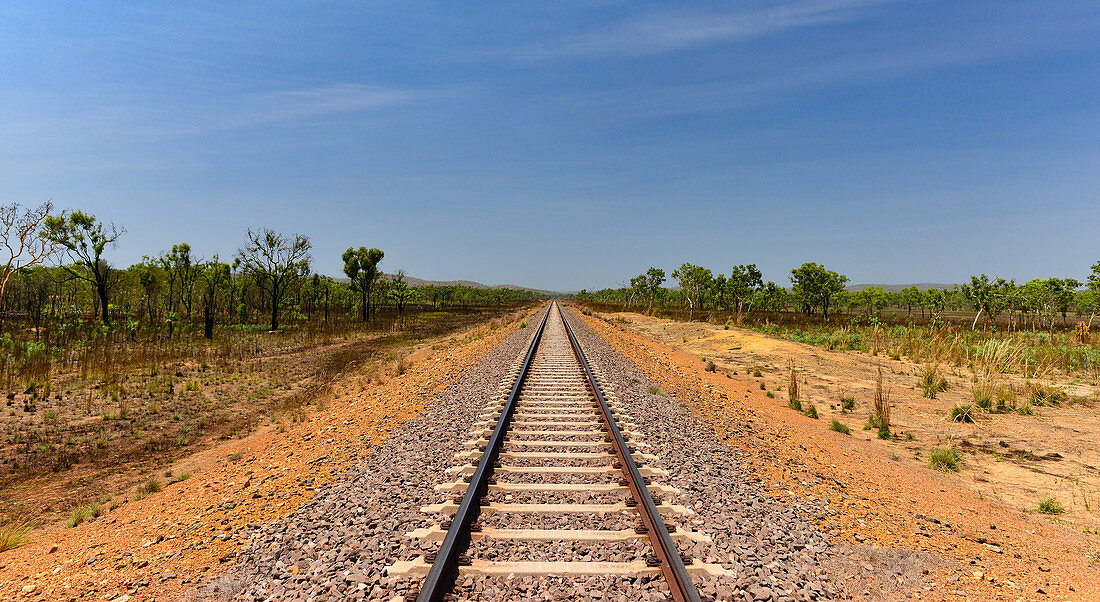 Endless, dead straight railroad track in the outback, near Pine Creek, Northern Territory, Australia