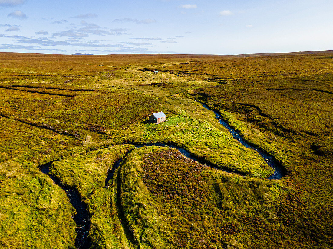 Aerial of a little hut in the Moorland on the Isle of Lewis, Outer Hebrides, Scotland, United Kingdom, Europe