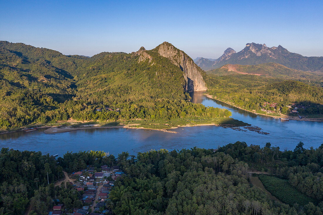 Aerial view of the village of Ban Muang Keo on the Mekong River with mountains behind, Ban Muang Keo, Chomphet District, Luang Prabang Province, Laos, Asia