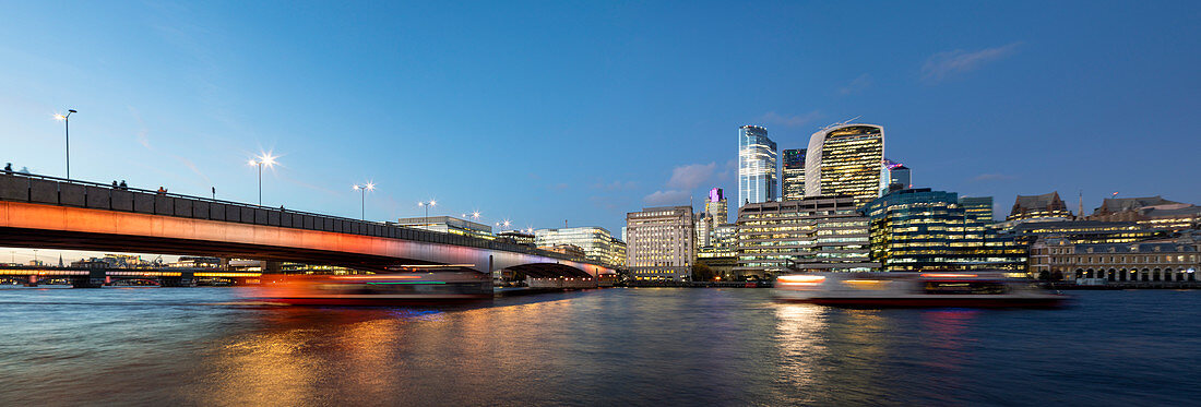 London Bridge across the River Thames lit up with colorful lighting, London, England, United Kingdom, Europe