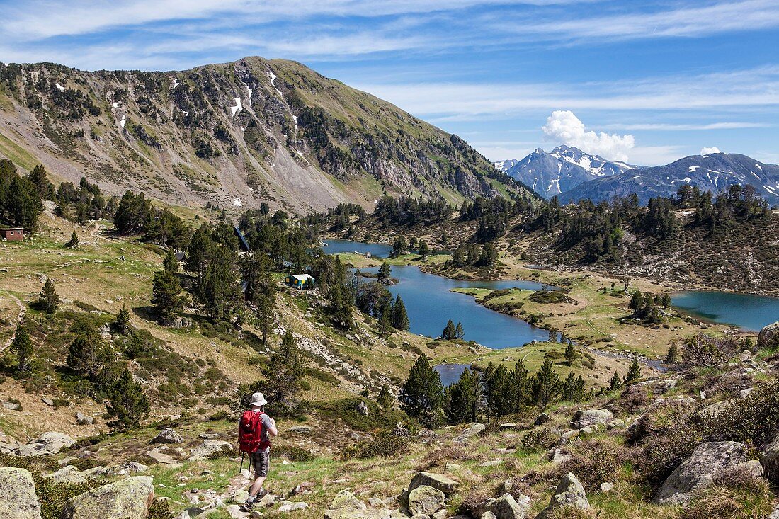 France, Hautes Pyrenees, hiker walking down to the refuge and lakes of Bastan, GR10 footpath