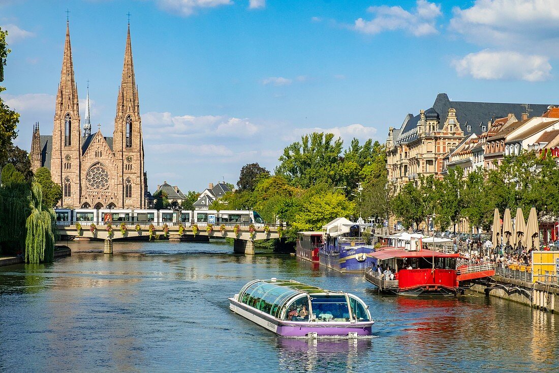 France, Bas Rhin, Strasbourg, old city listed as World Heritage by UNESCO, fly boat on Ill River with St Paul's Church in the background