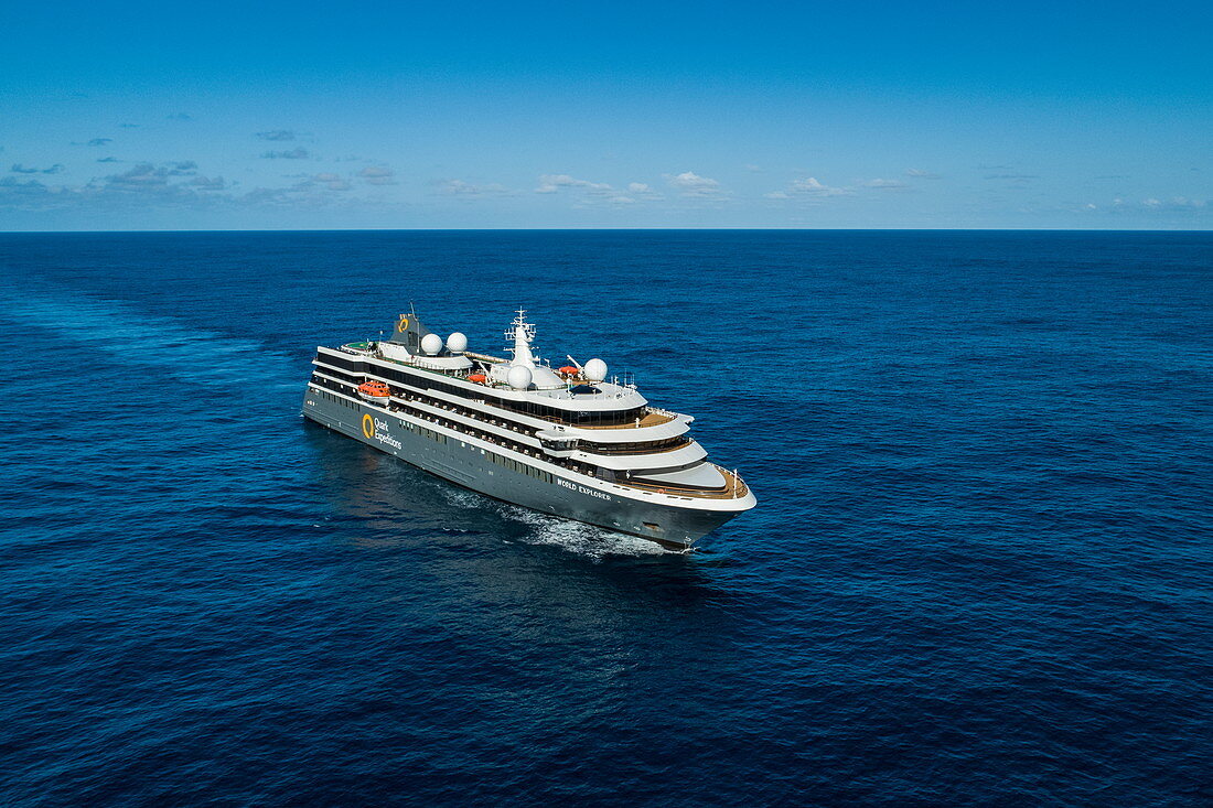 Aerial view of the expedition cruise ship World Explorer (nicko cruises) sailing through deep blue water in the South Atlantic, near Brazil, South America