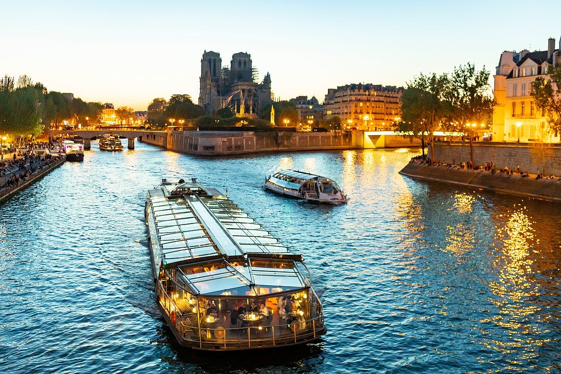 France, Paris, area listed as World heritage by UNESCO, a dinner cruise boat in front of Notre Dame