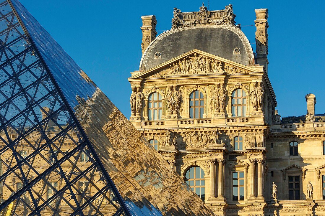 France, Paris, area listed as World Heritage by UNESCO, reflection of the facade of the Richelieu Wing on the pyramid of the Louvre by the architect Ieoh Ming Pei in the Cour Napoleon