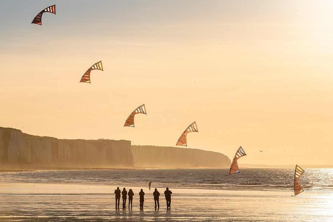 Frankreich, Somme, Ault, Team von Cervicists, die synchronisiertes Drachenfliegen am Strand von Ault in der Nähe der Klippen bei Sonnenuntergang trainiert