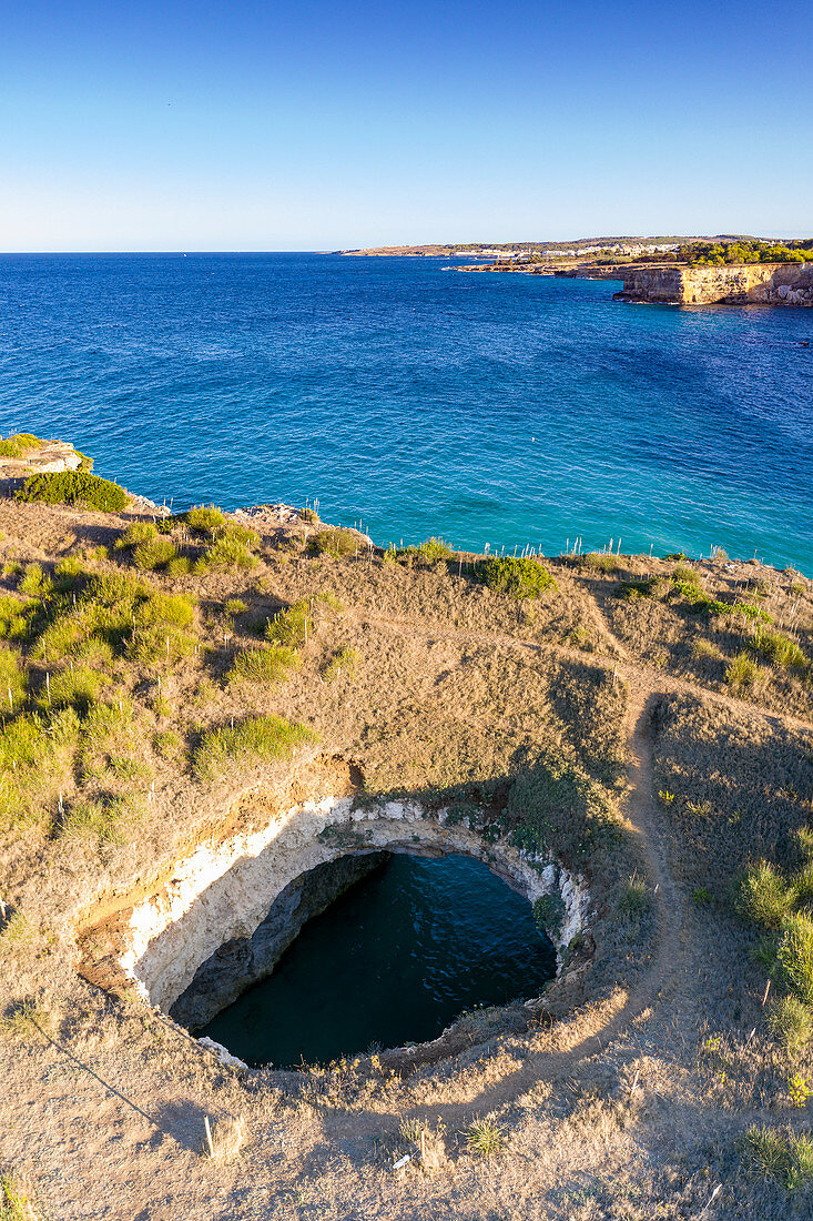 Natural stone arch and open grotto framed by turquoise sea, Otranto, Lecce province, Salento, Apulia, Italy, Europe