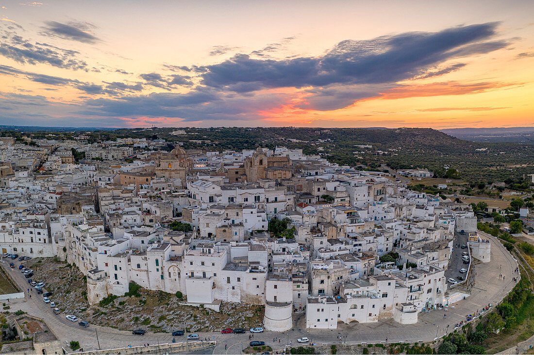 Aerial panoramic of white buildings in the old town of Ostuni at sunset, province of Brindisi, Salento, Apulia, Italy, Europe