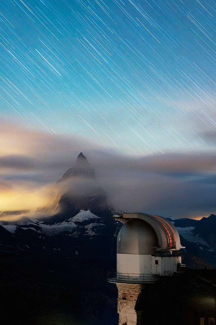 Star trail in the night sky on Matterhorn from observatory tower of Kulmhotel Gornergrat, Zermatt, Valais canton, Switzerland, Europe