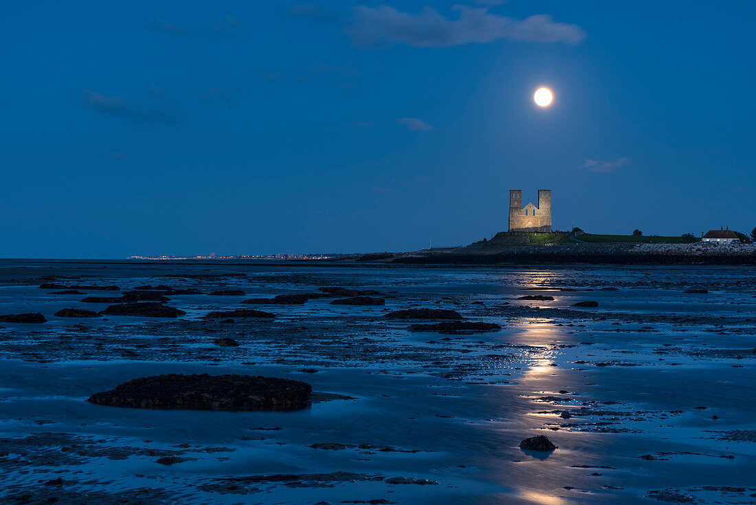 Full moon rising over Reculver Towers, beach at low tide, Reculver, Herne Bay, Kent, England, United Kingdom, Europe