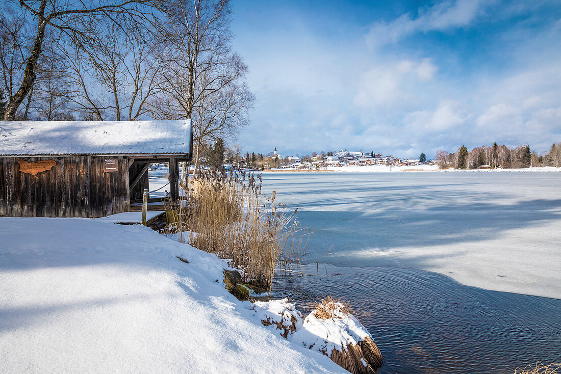 Boathouse on the shore of the frozen Lake Bayersoien, Bad Bayersoien, Upper Bavaria, Bavaria, Germany