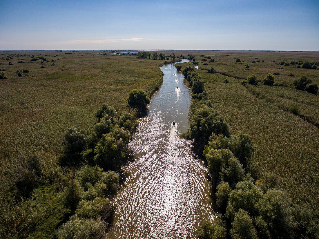 Aerial view of motorboat excursion to wetlands in the Volga Delta, near Karalat, Ostrakhan District, Russia, Europe