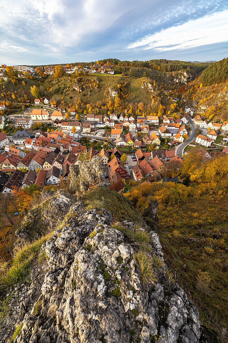 View of Pottenstein with autumn leaves from a rocky hill, Upper Franconia, Bavaria, Germany