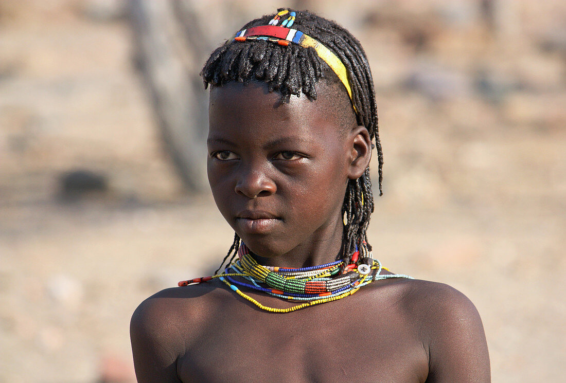 Angola; western part of the province of Cunene; young girl from the Mucohona ethnic group; with typical head and neck jewelry