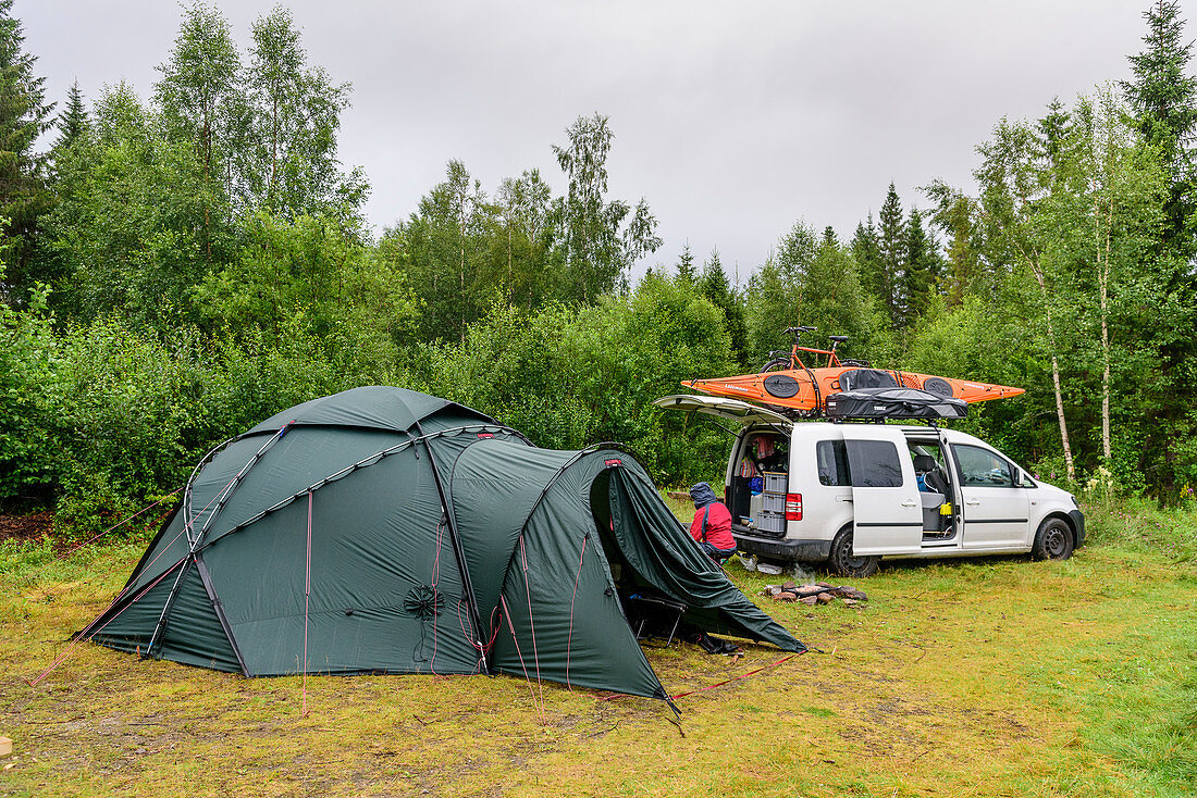Family camping in the wild by the Vefsna river, Norway