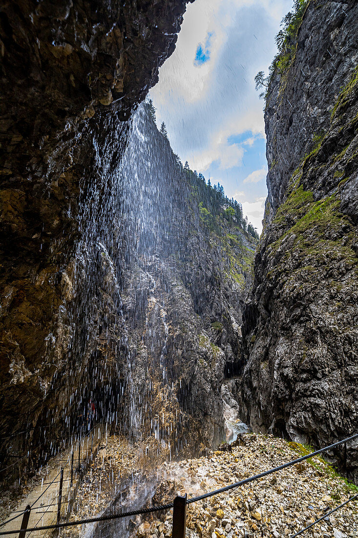 View through waterfall in the Höllentalklamm, Grainau, Upper Bavaria, Germany