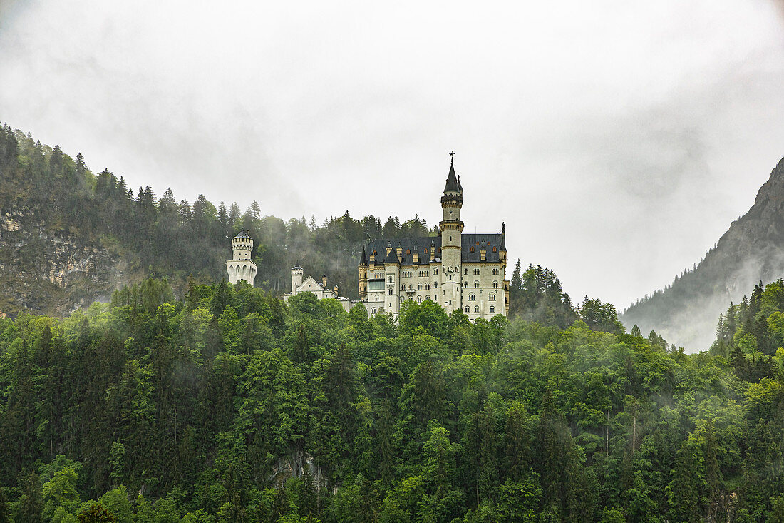 View of Neuschwanstein Castle with clouds and mountains in the background, Schwangau, Upper Bavaria, Germany