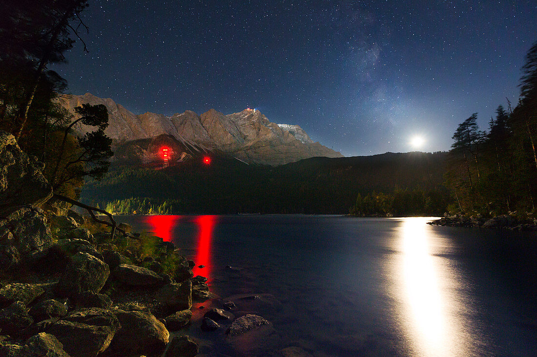Night sky with moon and Milky Way at Eibsee, view to Zugspitze, Werdenfelser Land, Bavaria, Germany