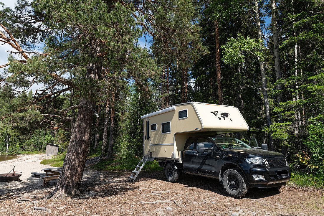 A van is parked on the bank of a lake in summer, Skalmsjö, Västernorrland, Sweden