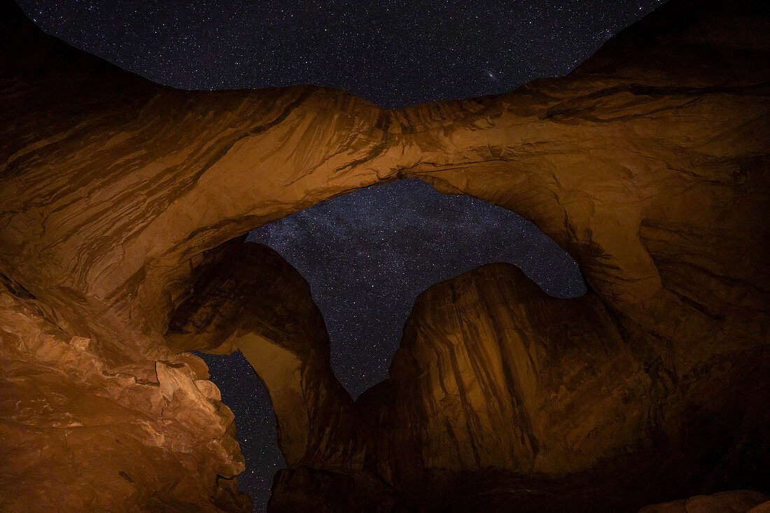 View of stars through Double Arch, Arches National Park, Utah, United States of America, North America